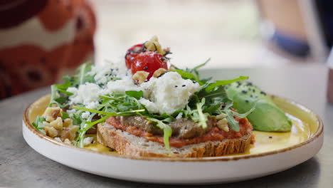 gourmet toast with fresh arugula and cheese on plate