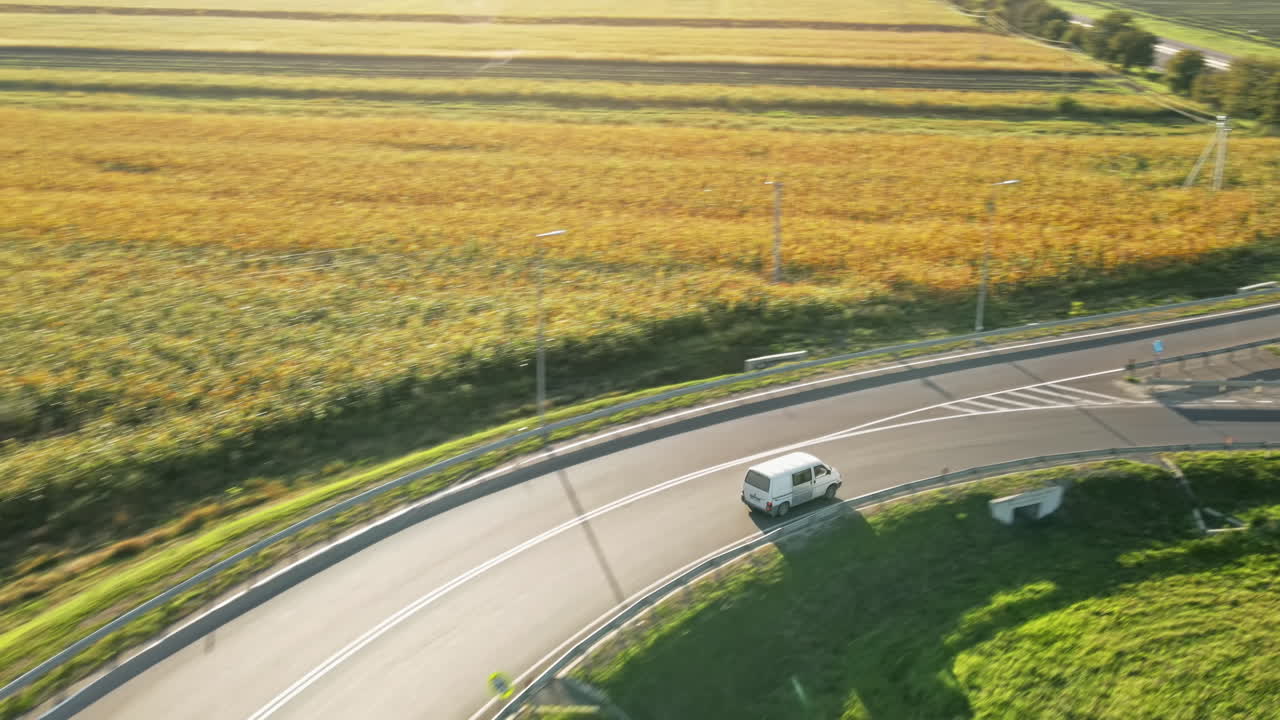 Aerial drone view of a road junction with moving cars and nature, greenery, fields, Moldova