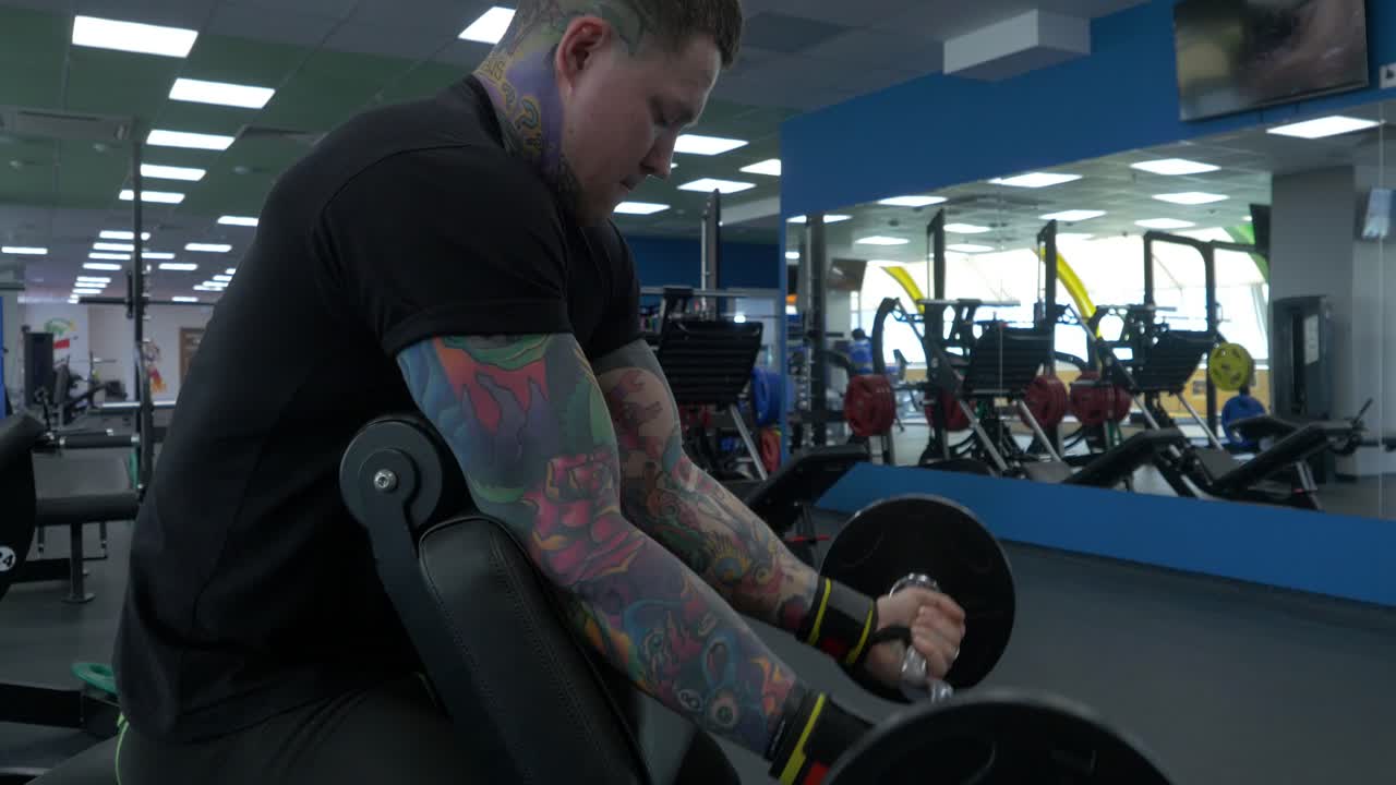 Man performing barbell bicep curls in a gym