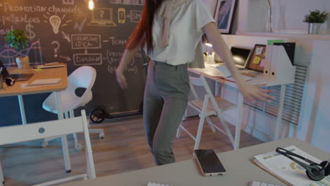 young woman dancing in office/home office