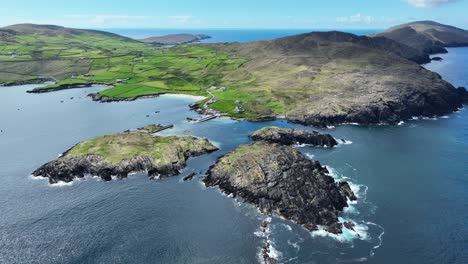 drone spectacular landscapes of west cork in ireland,durnesy island in background at the end of remote peninsula and little sheltered fishing harbour under the protection of the mountains