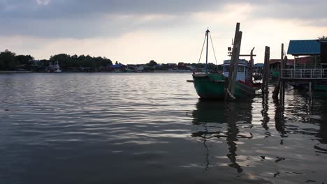 an anchored wooden trawler along the river of bang tabun in thailand