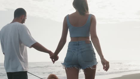 man and woman walking on beach