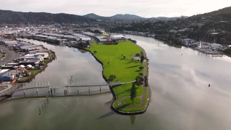 hihiaua park connected by walking bridge in whangarei city, new zealand - drone shot