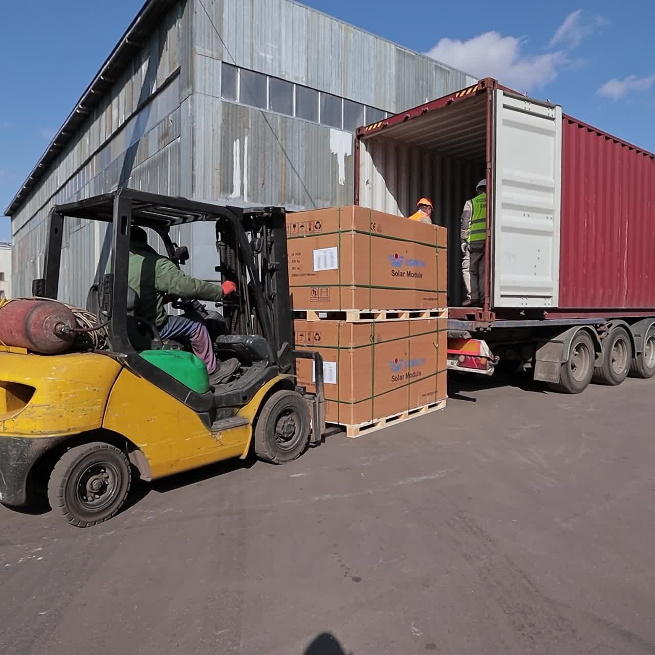 Uploading boxes of goods from the truck. Industrial forklift factory specialist
