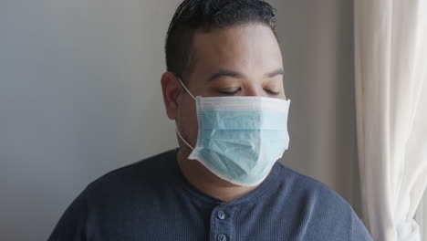 young hispanic male removing his face mask