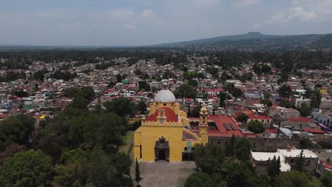 drone view of xochimilco cathedral with southern mexico city's urban scenery