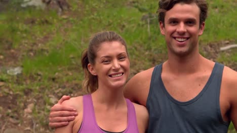 Smiling-jogger-couple-posing-for-camera-