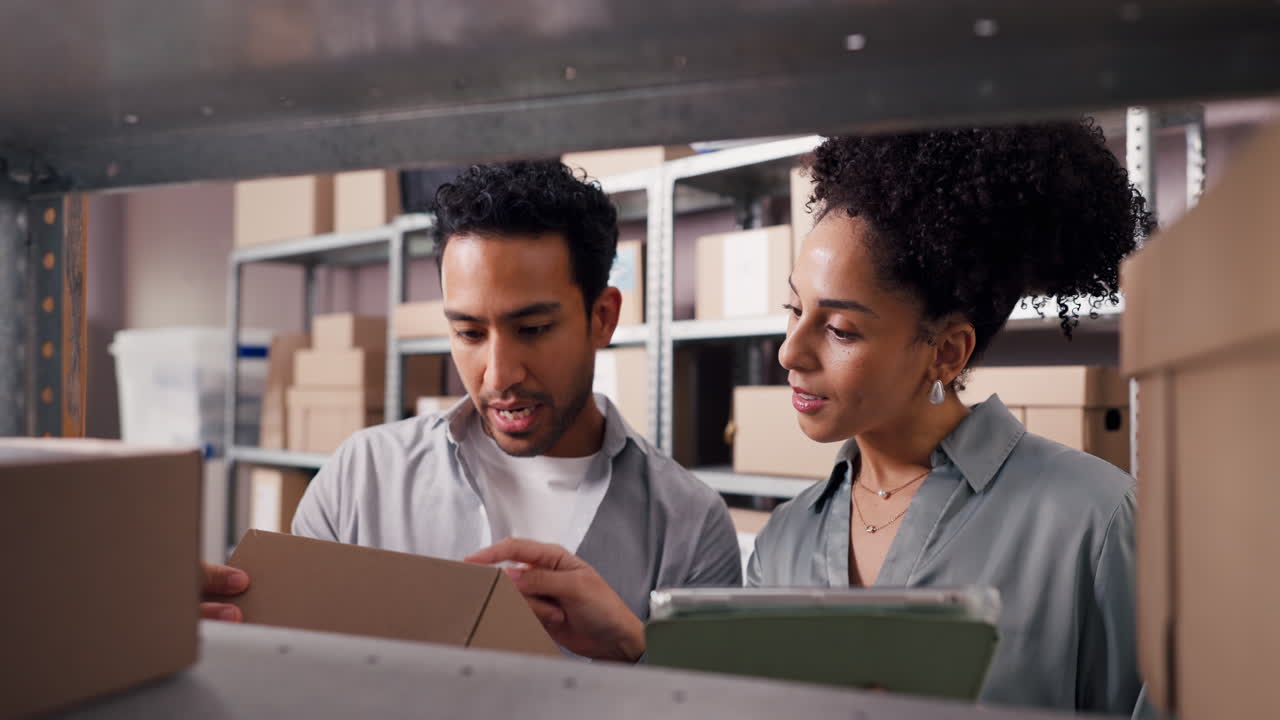 Man and Woman Checking Inventory in a Warehouse