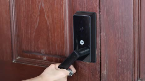 person using a smart lock on a wooden door