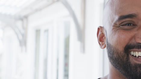 Half-portrait-of-happy-biracial-man-at-home-with-copy-space,-slow-motion