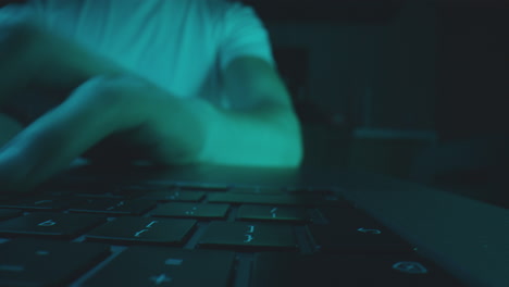 Hands Typing on a Keyboard at Night