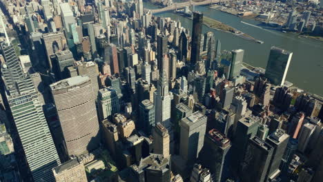 Midtown-development,-mixture-of-various-high-rise-buildings-on-sunny-day.-River-and-Queensboro-Bridge-in-background.-Manhattan,-New-York-City,-USA