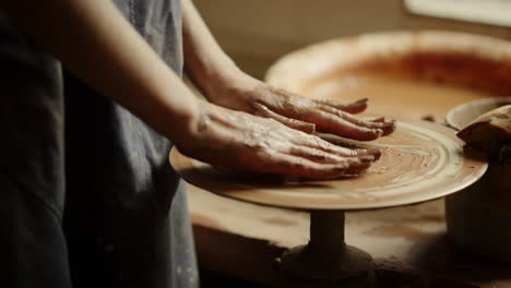 Unrecognized-lady-waiting-for-clay-in-pottery.-Girl-having-rest-before-sculpting