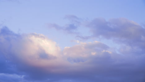 The-moon-peaks-through-the-clouds-at-sunset