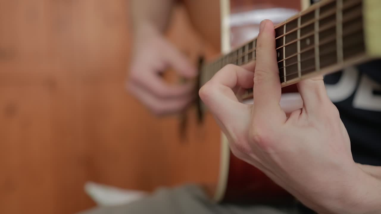 Close-up of a Man Playing Acoustic Guitar