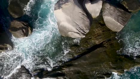 Slow-motion-Aerial-Waves-Breaking-On-Rocks-steady-long-shot