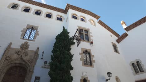 white historic facade with ornate windows at palau de maricel in sitges spain