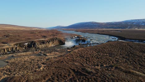 Icelandic-river-and-waterfall-with-mountains-on-the-background-drone-show-in-4K-3