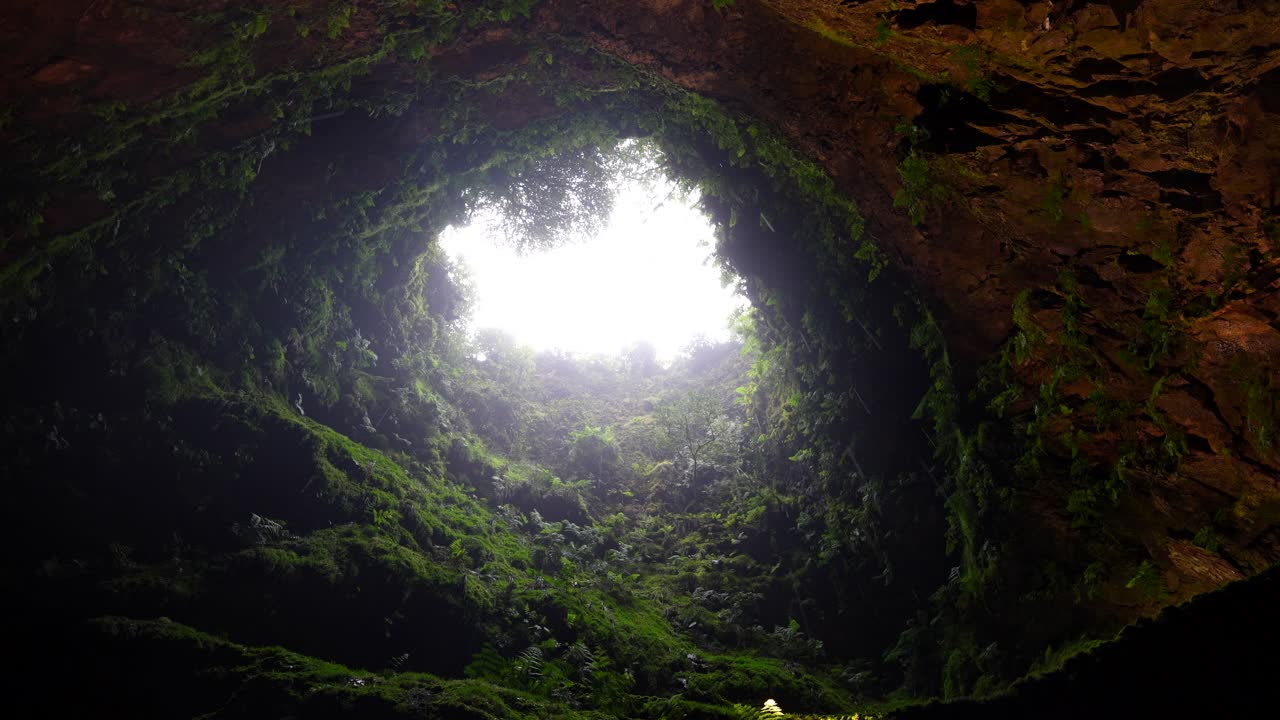 Raindrops fall through Algar do Carvao hole in Terceira, Azores