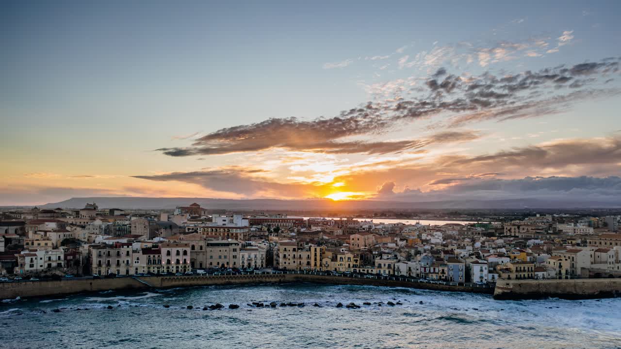 Drone Hyperlapse of Ortigia island at sunset. Beautiful colors in sky. UNESCO world heritage site in Syracuse, Sicily.