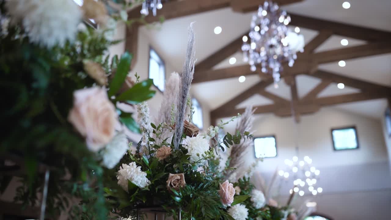 Flowers are displayed on a long table at their Texas Hill Country wedding