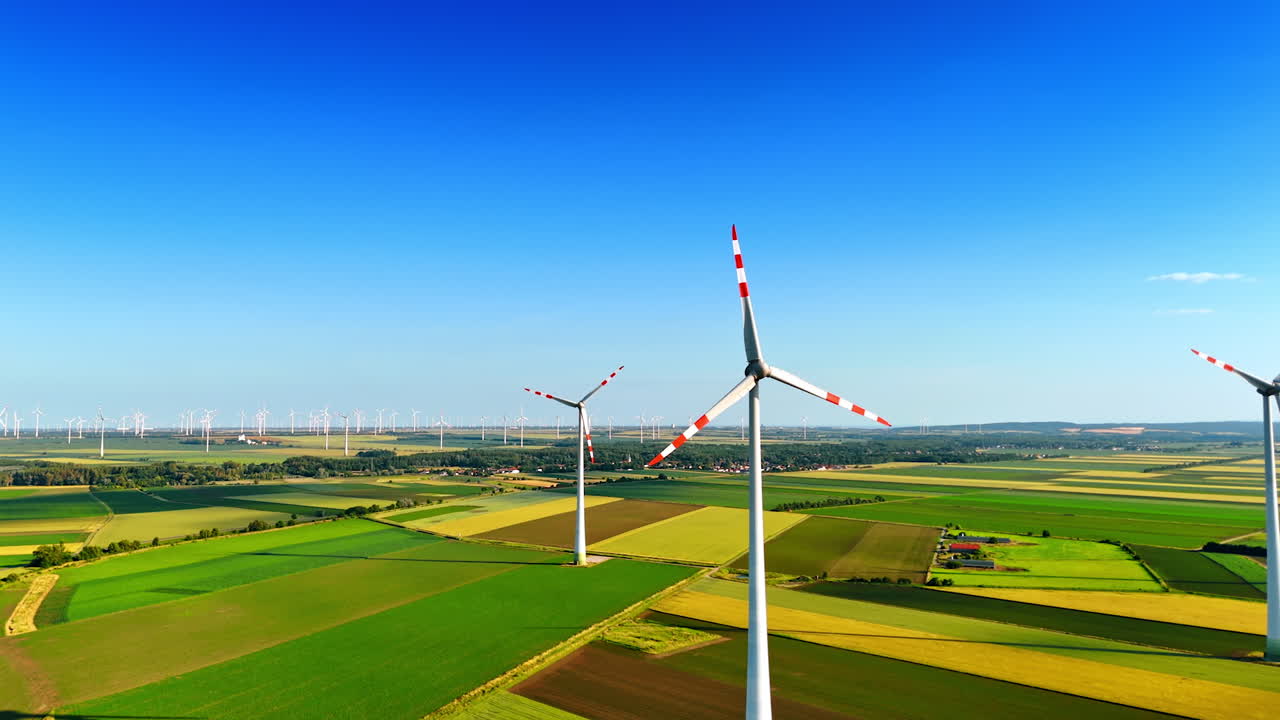 Clean energy from wind turbines. Wind turbines stand tall in a lush green landscape, promoting renewable energy in a European countryside setting