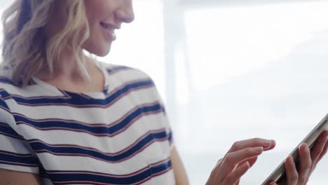 Blonde woman using digital tablet