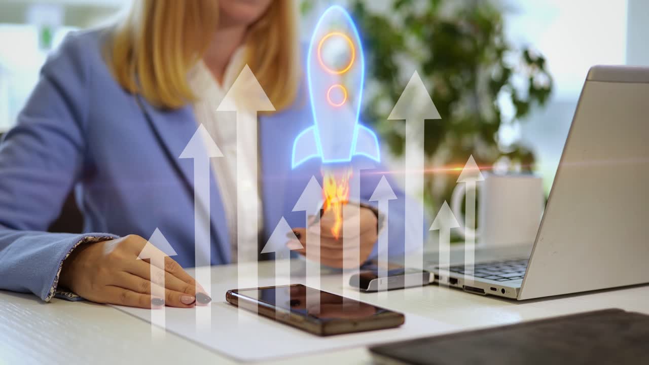Professional modern business woman working at her desk while animation of digital arrows and a glowing rocket launch upward, symbolizing a startup's rapid progress and company reaching new heights