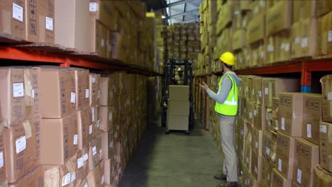 warehouse worker directing forklift driver