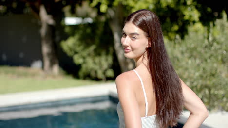 Teenage-Caucasian-girl-with-long-brown-hair-smiles-outdoors-with-copy-space