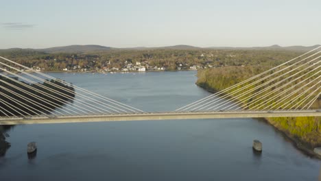 flying over the penobscot narrows bridge during autumn golden hour aerial