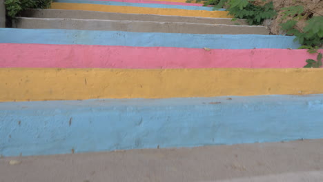 walking up the colourful outdoor stairway