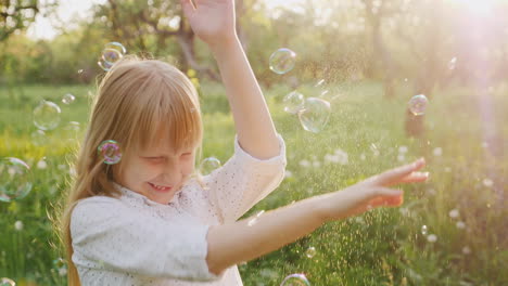 Blonde-Girl-Is-Fun-Catching-Soap-Bubbles-Carefree-Happy-Child-Slow-Motion-Video