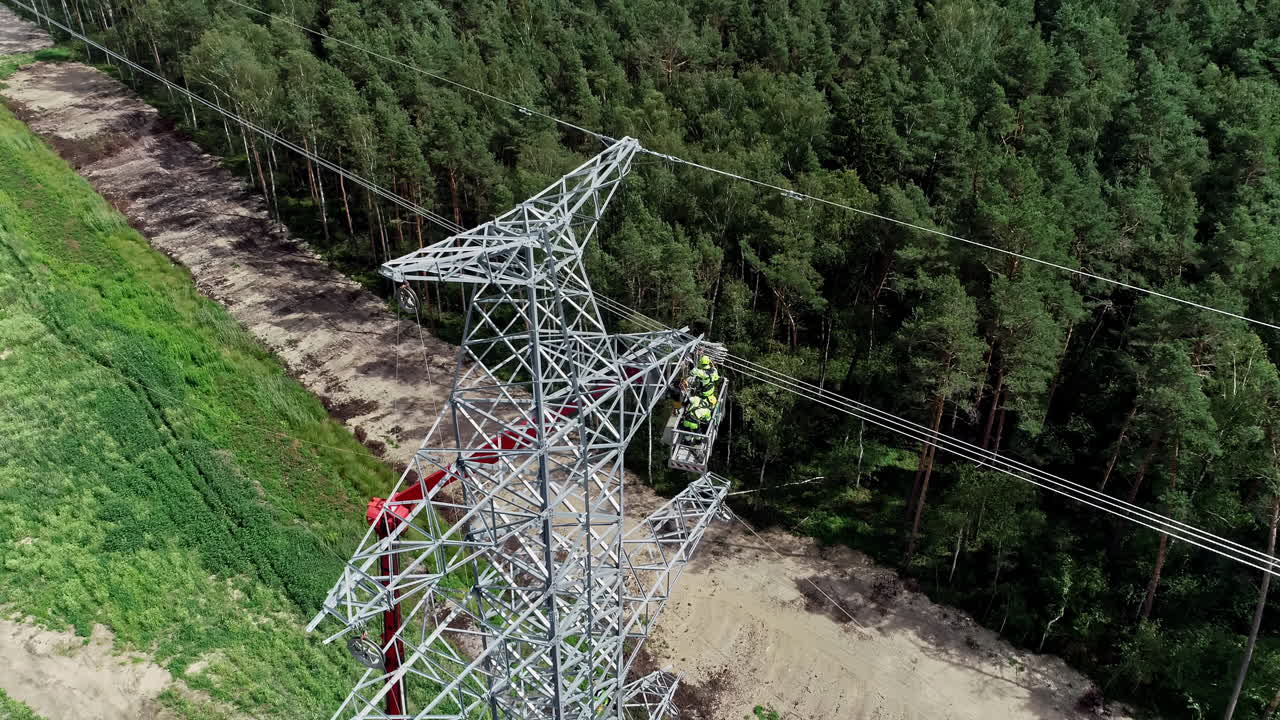 trabajador de la línea con equipo de protección reparando la línea eléctrica dañada en la torre de transmisión