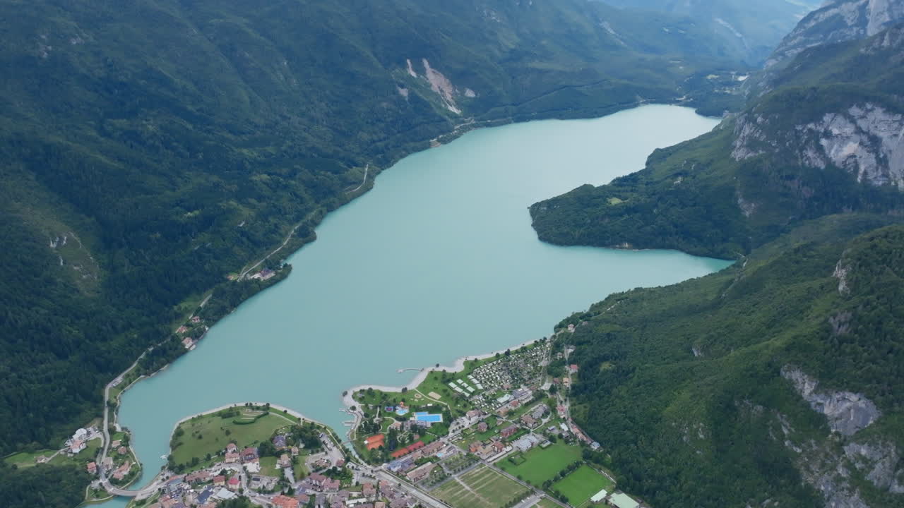 High aerial footage over the lake in the Italian town of Molveno in northern Italy.