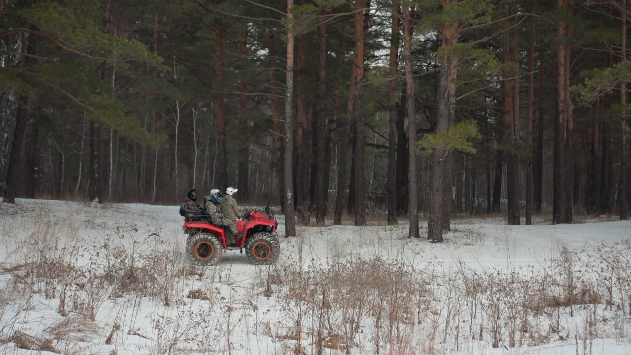 Serena avventura innevata. Viaggio solitario attraverso la foresta invernale. Motocicletta silenziosa che esplora il freddo paesaggio boschivo. Pilota solitario che percorre una tranquilla pineta innevata durante l'inverno.