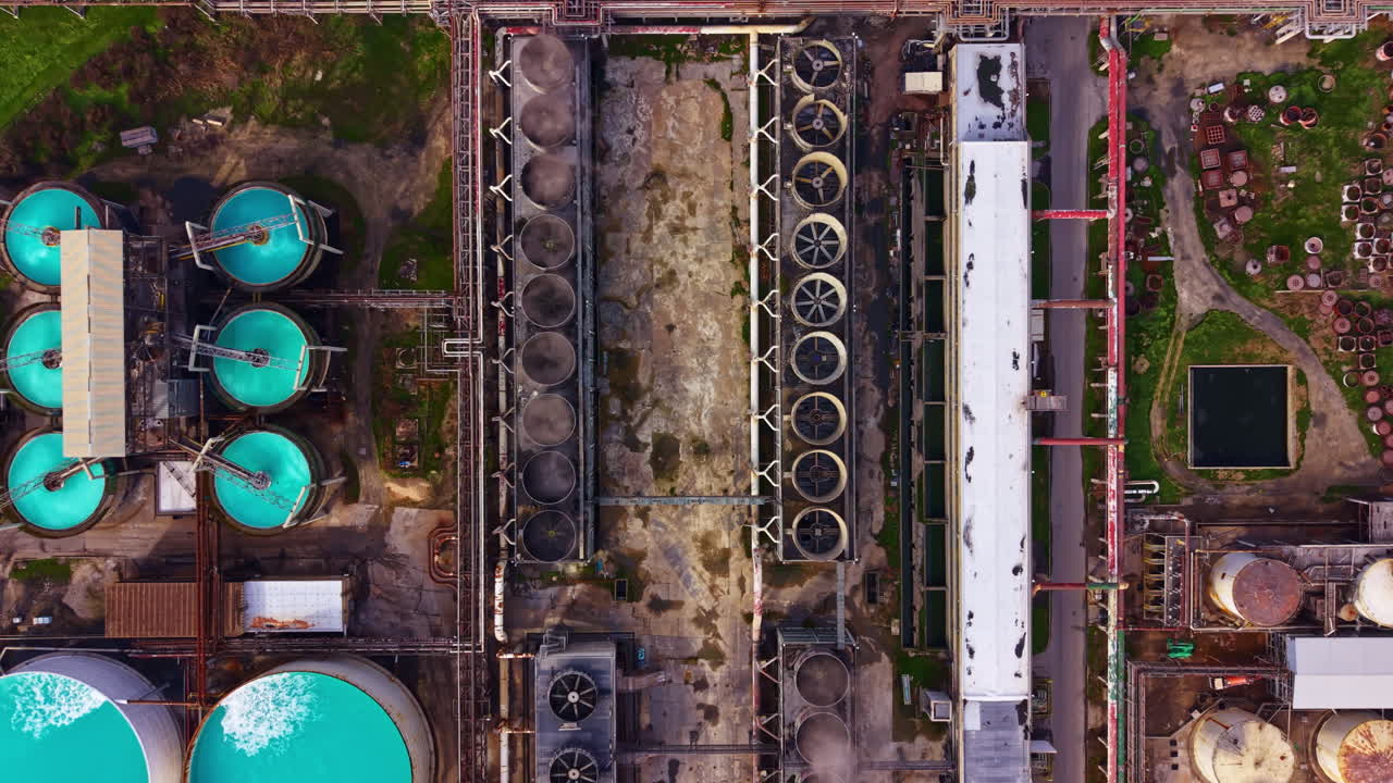 Water treatment facility in operation with multiple storage tanks and processing units shown from above during daytime
