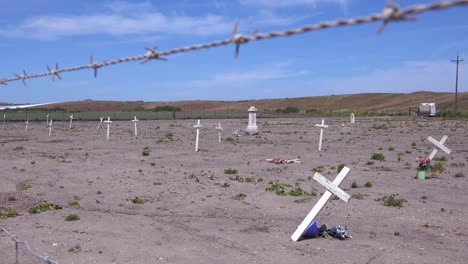 the graves of unknown mexican immigrant hispanic farm workers are marked by crosses in a graveyard cemetery near guadeloupe 4