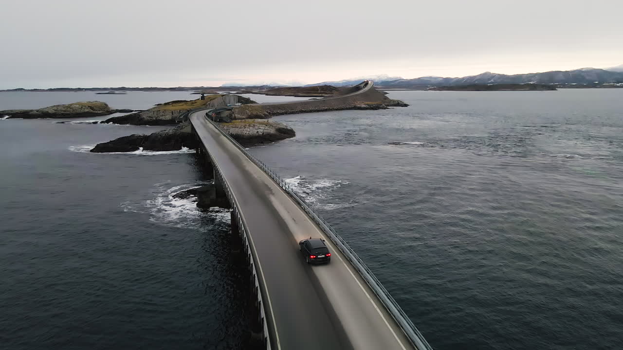 Atlantic Ocean Road - BMW Car Drives In Hulvagen Bridge Towards The Mainland In Norway. - aerial
