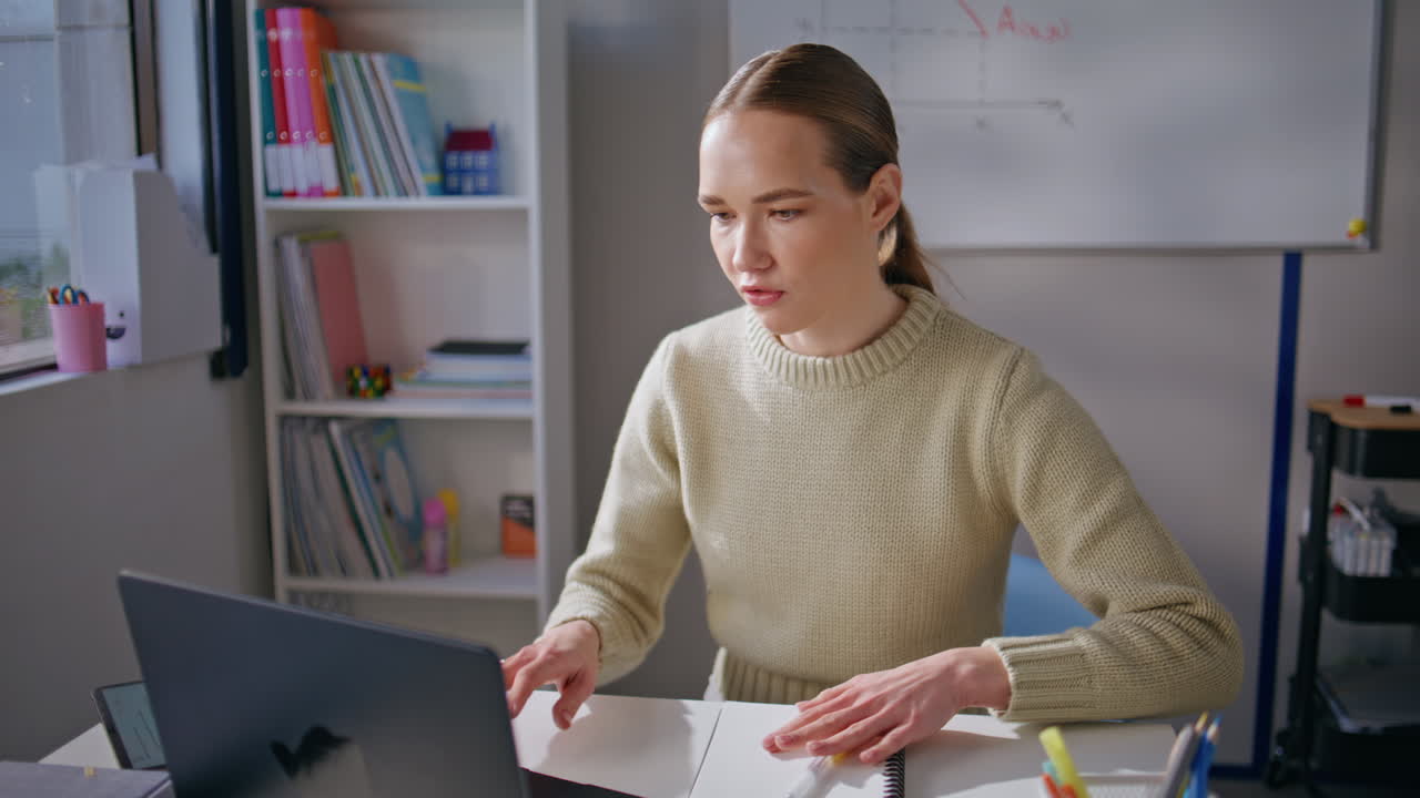 Smiling tutor videocalling remotely class room closeup. Lecturer explaining math