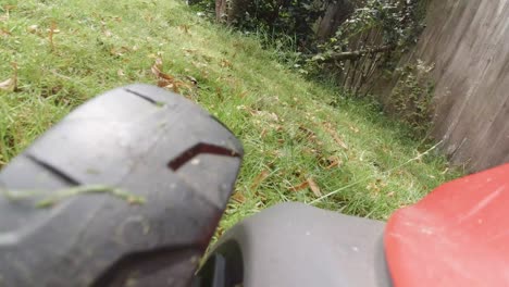 POV-Close-Up-of-Electric-Lawnmower-Wheel-Mowing-the-Grass