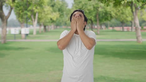 tired and lazy indian man yawning