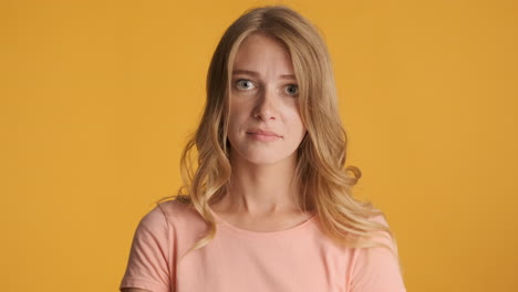 upset caucasian woman waving hand on camera.