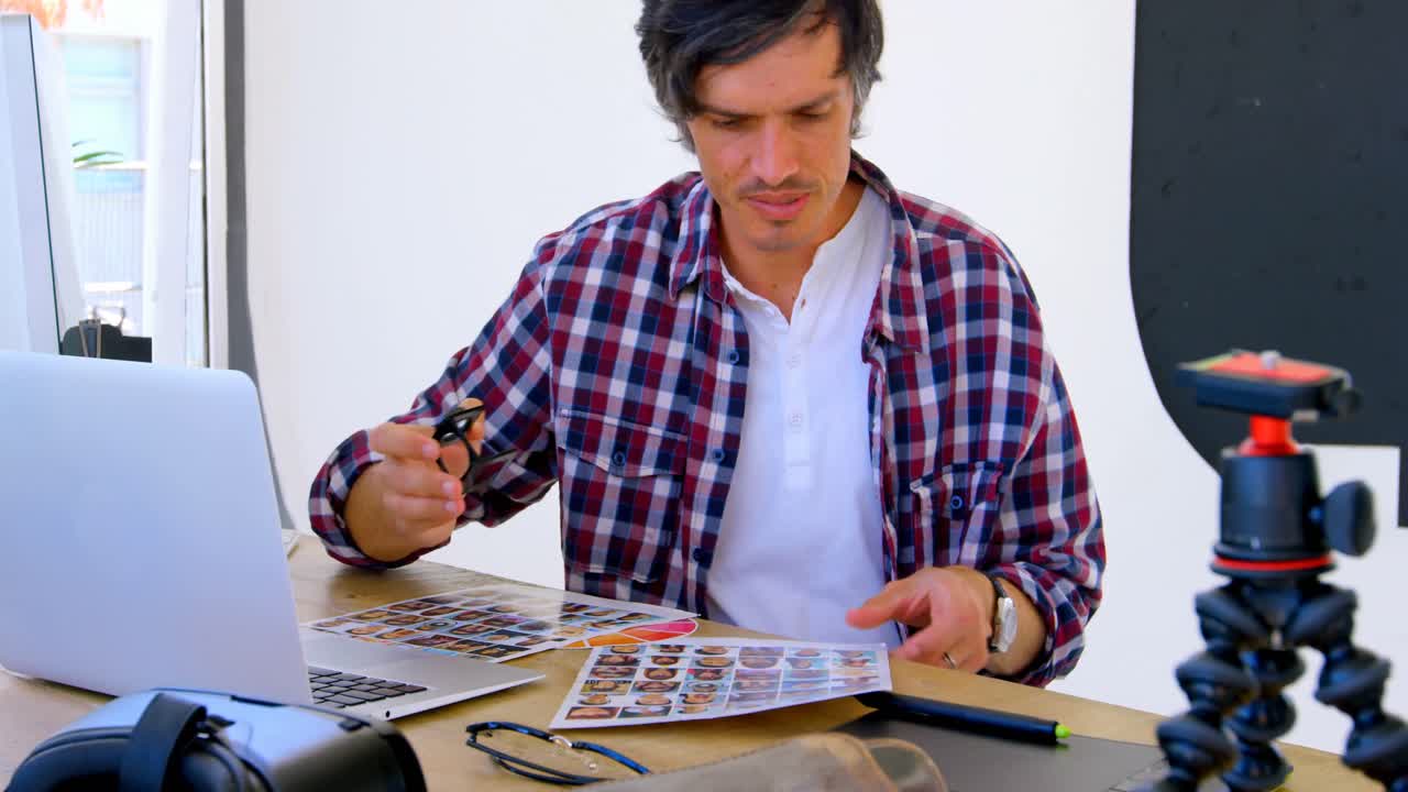 fotógrafo masculino comprobando fotos con lupa 4k