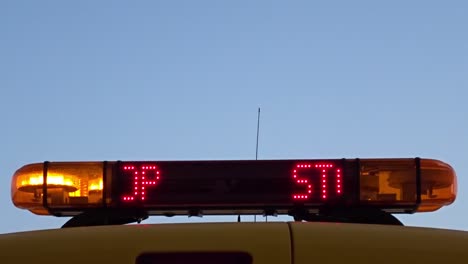 close up of an airport marshaller sign showing the text "stop" and "follow me