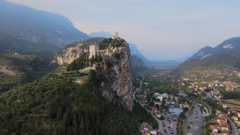 picturesque old arco castle on cliff above riva del garda city, trentino, italy