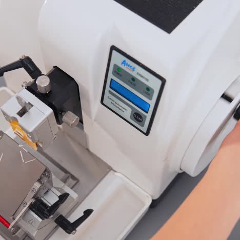 laboratory with sample from patient. nurse feeds data of test tubes for analysis