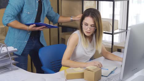 la pareja de empresarios está preparando cajas de paquetes para ser entregadas al cliente en la oficina del hogar.