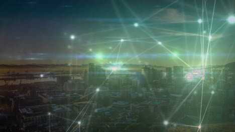 network of connections and data processing animation over cityscape at dusk